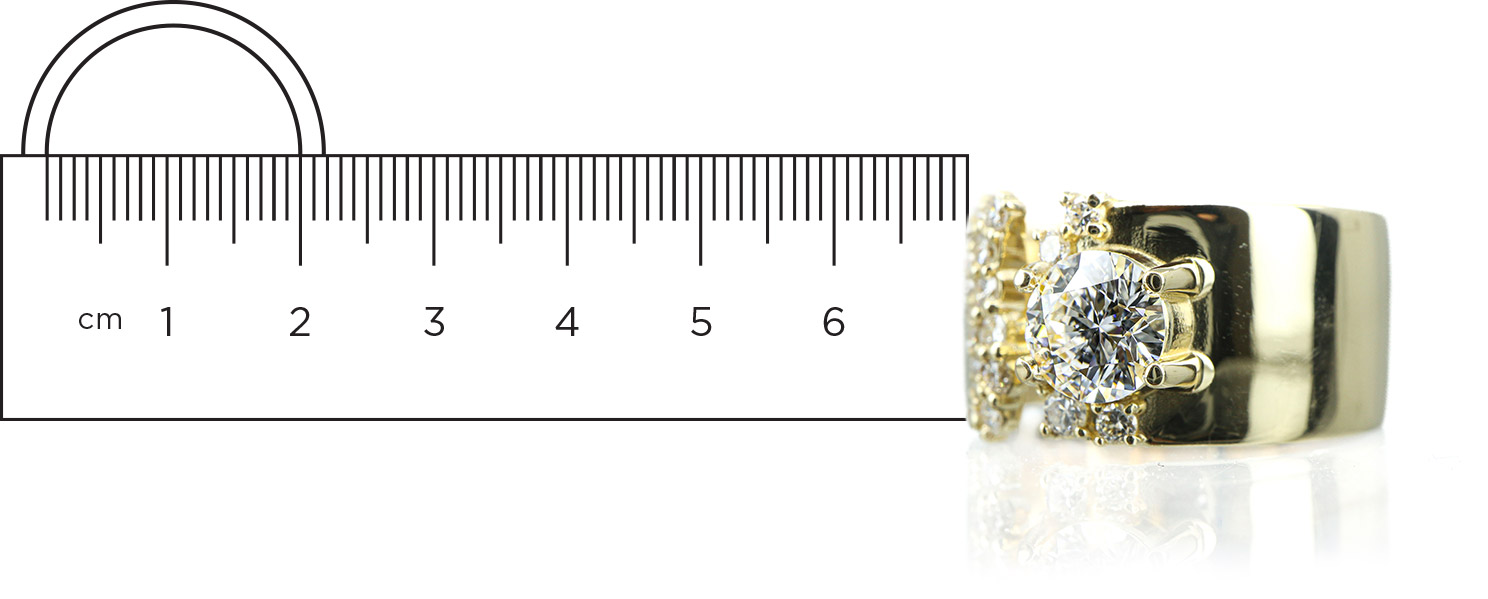A gold ring with a ruler next to it.