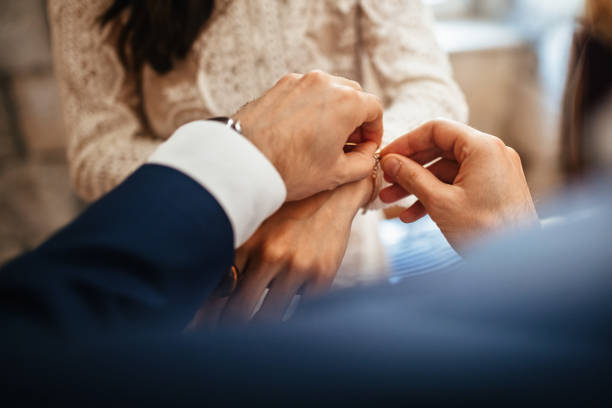 A man gently fastening a bracelet on a woman's wrist, showcasing elegant jewelry options