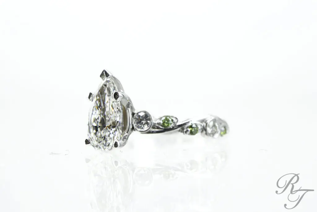 Intricate green and diamond ring perfect for bridal jewelry collections