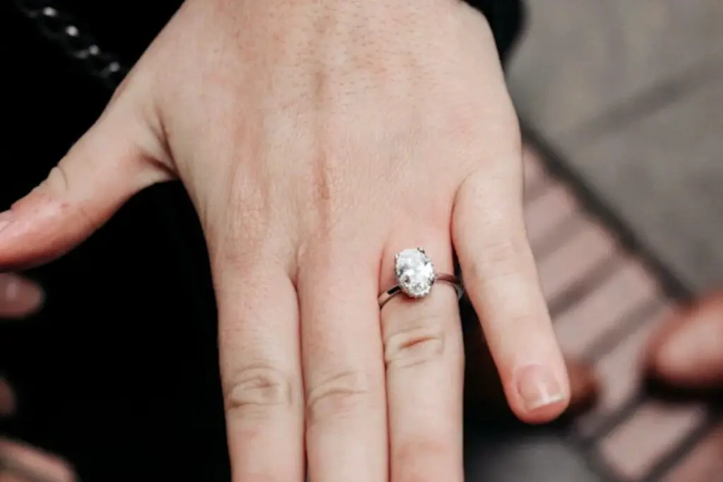 Adjusted oval engagement ring on woman's hand