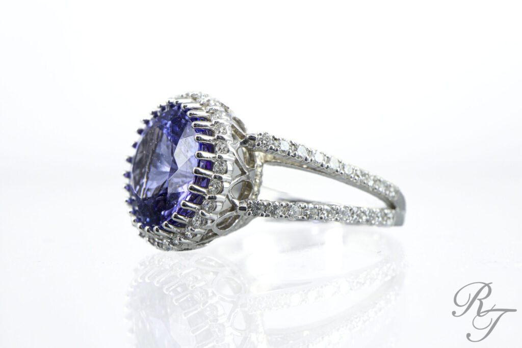 Sapphire gemstone ring surrounded by diamonds on a silver band – a unique engagement ring alternative