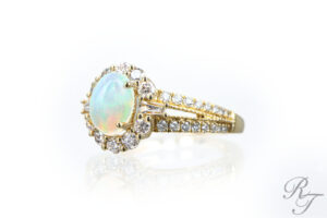 Opal engagement ring with diamond halo and gold band