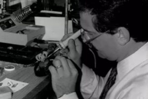 A black and white photo of Rick Terry, the founder, working on a piece of jewelry in his workshop, a key part of the Rick Terry Family Legacy.