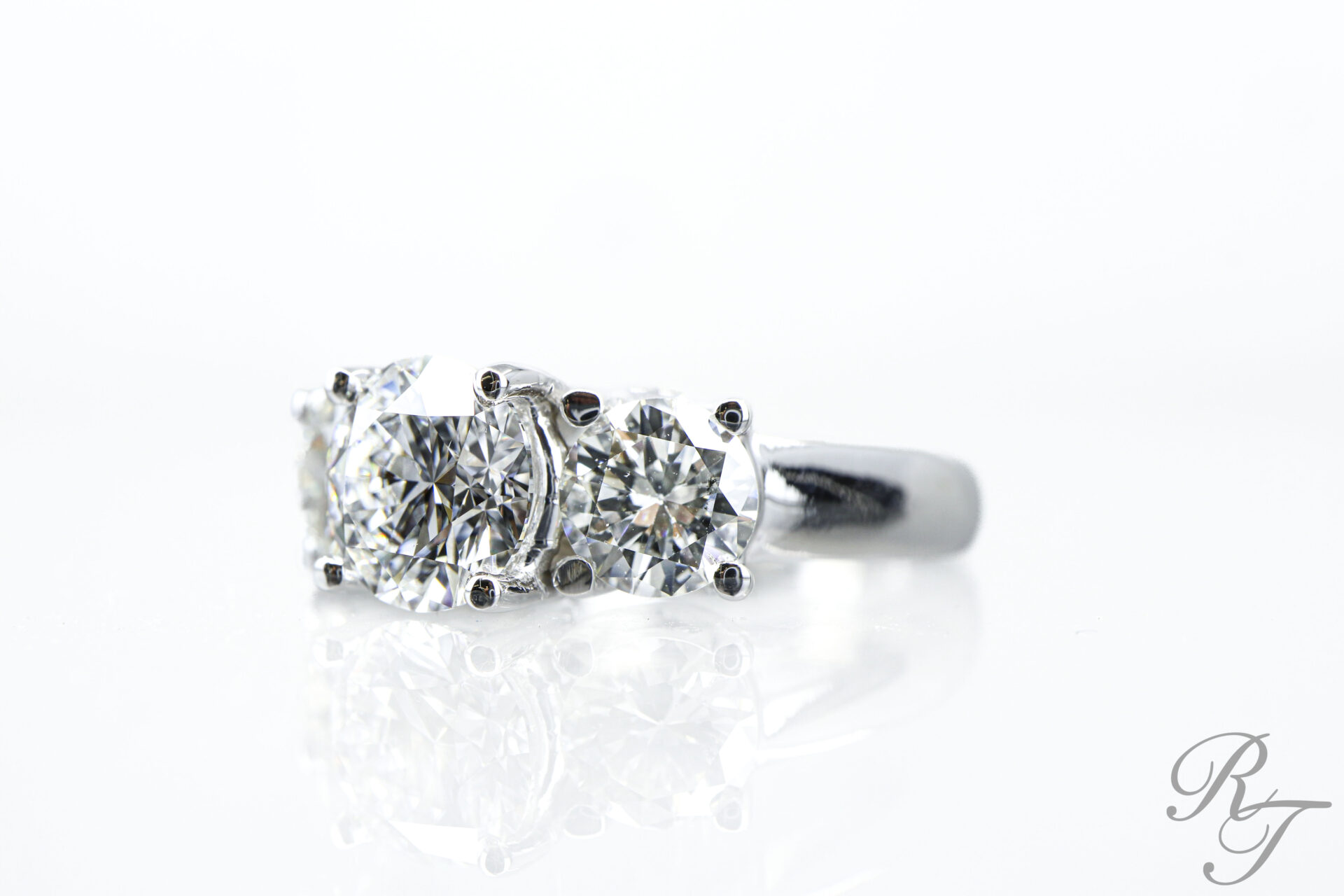 Alt Text: Close-up of a three-stone diamond engagement ring in Knoxville TN showing secure prong settings and brilliant cut diamonds.