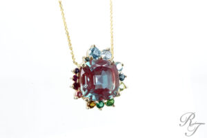 A vibrant alexandrite and multi-gemstone halo pendant necklace from Rick Terry Jewelry Designs, highlighting expert jewelry stone replacement in Knoxville.