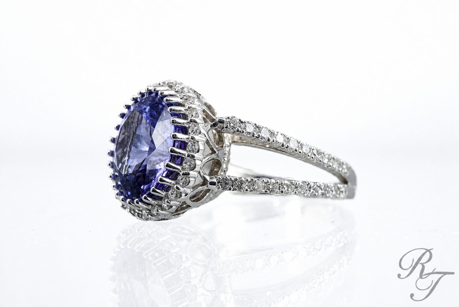 Custom tanzanite halo ring with diamond pave split shank designed by Rick Terry Jewelry in Knoxville