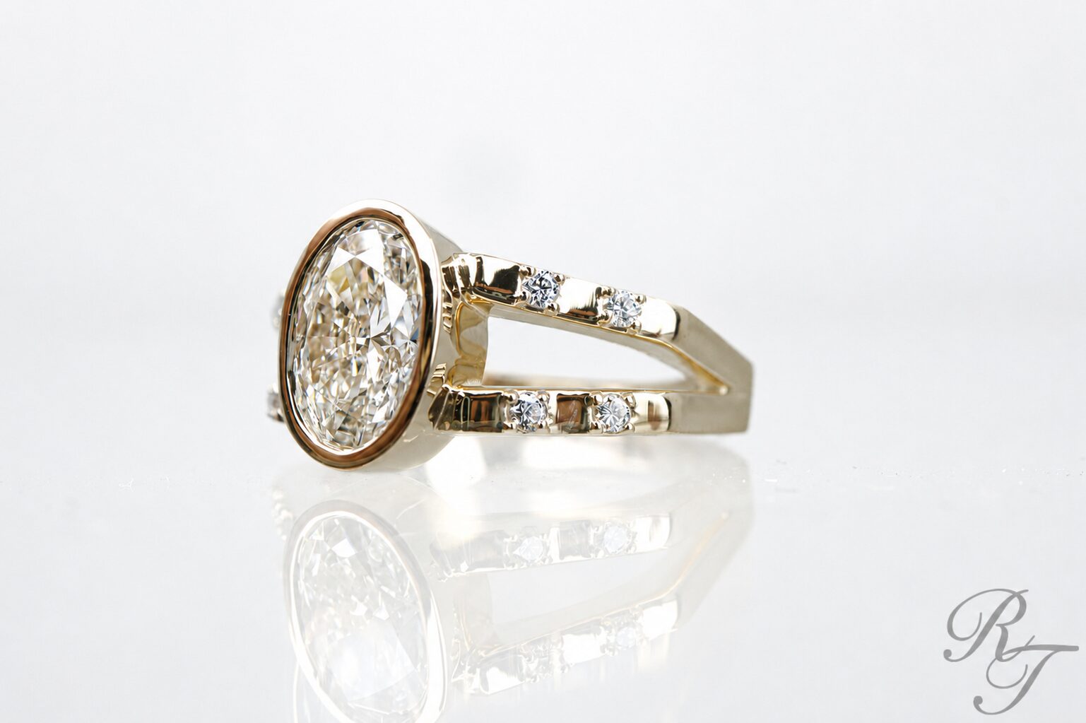 Custom bezel set oval diamond ring in two-tone gold by Rick Terry Jewelry Knoxville