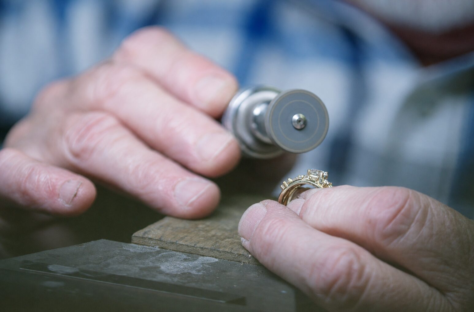 Master jeweler at Rick Terry Jewelry in Knoxville hand-finishing a custom ring at the workbench