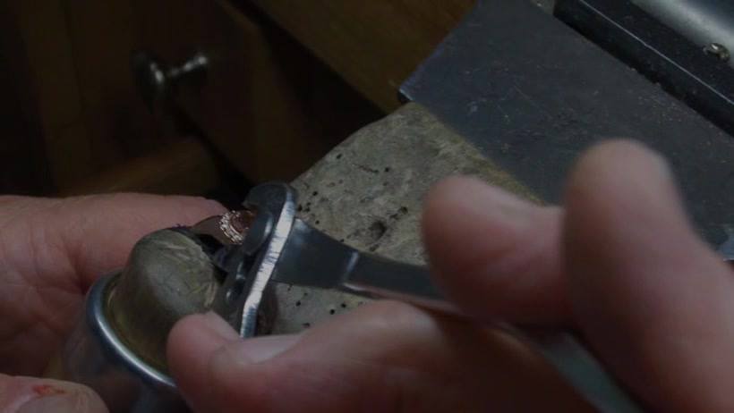Expert jeweler performing ring sizing Knoxville at Rick Terry Jewelry Designs workbench