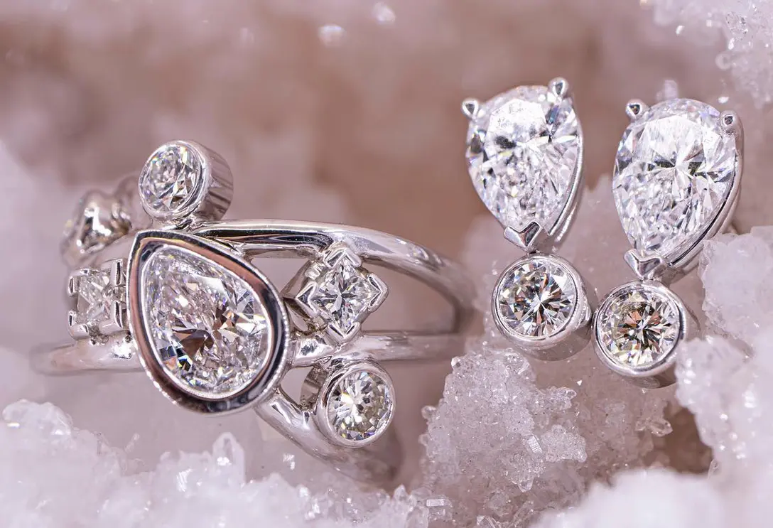 Custom pear diamond bezel ring with matching pear and round diamond drop earrings crafted by Rick Terry Jewelry Designs Knoxville