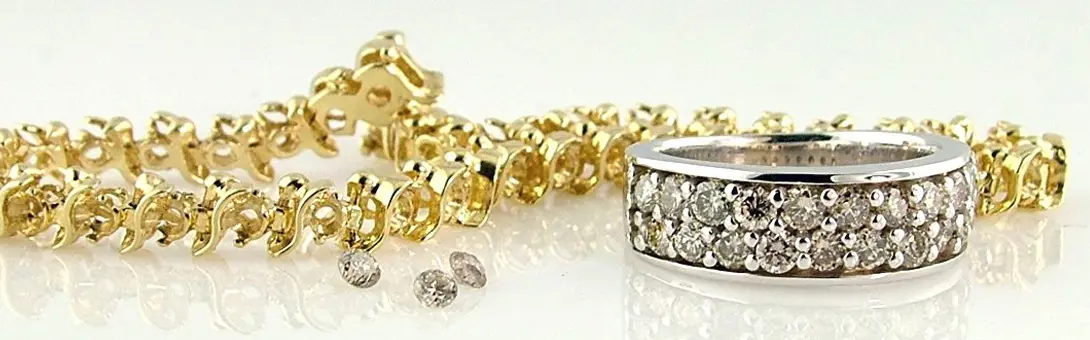 Gold tennis bracelet and white metal three-row pave diamond band with loose diamonds at Rick Terry Jewelry Designs Knoxville TN
